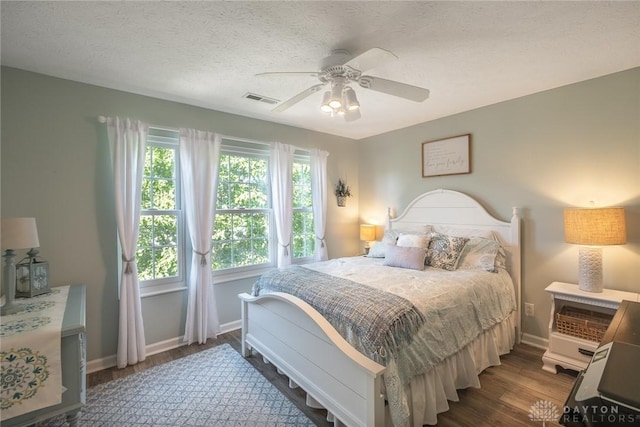 1199 Whitetail Dr, Fairborn, OH 45324 - bedroom featuring baseboards, wood finished floors, a ceiling fan, and a textured ceiling