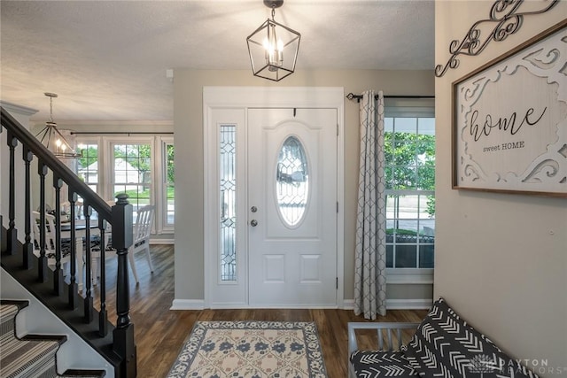 1199 Whitetail Dr, Fairborn, OH 45324 - foyer entrance with stairway, a chandelier, dark wood-type flooring, baseboards, and a textured ceiling