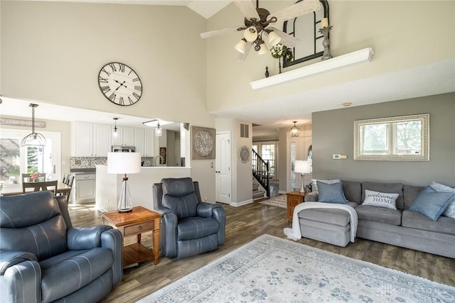 1199 Whitetail Dr, Fairborn, OH 45324 - living room featuring a ceiling fan, wood finished floors, high vaulted ceiling, stairway, and baseboards