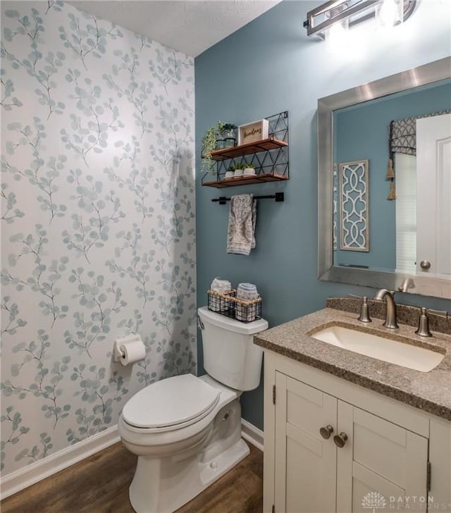 1199 Whitetail Dr, Fairborn, OH 45324 - bathroom featuring wood finished floors, toilet, baseboards, and vanity
