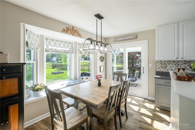 1199 Whitetail Dr, Fairborn, OH 45324 - dining room with wood finished floors, a chandelier, and baseboards