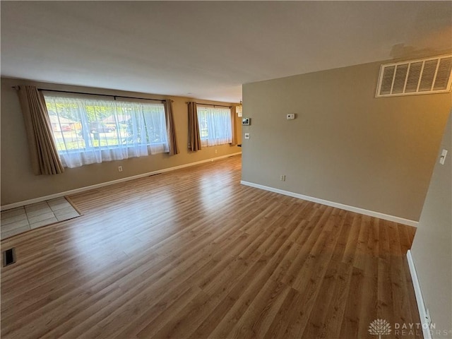 3645 Endover Rd, Dayton, OH 45439 - unfurnished room with wood finished floors, healthy amount of natural light, and baseboards