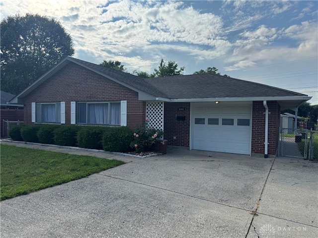 3645 Endover Rd, Dayton, OH 45439 - ranch-style house with brick siding, an attached garage, driveway, a gate, and roof with shingles