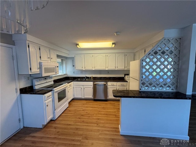 3645 Endover Rd, Dayton, OH 45439 - kitchen featuring white appliances, white cabinetry, light wood-type flooring, a sink, and tile counters