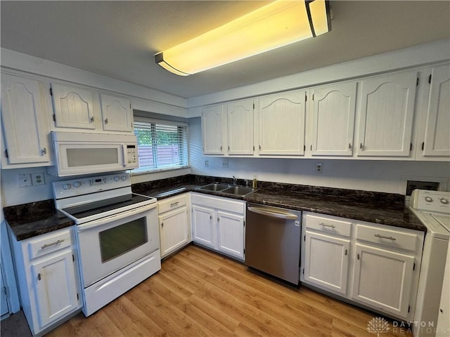 3645 Endover Rd, Dayton, OH 45439 - kitchen with white appliances, a sink, washer / dryer, light wood-style floors, and white cabinets