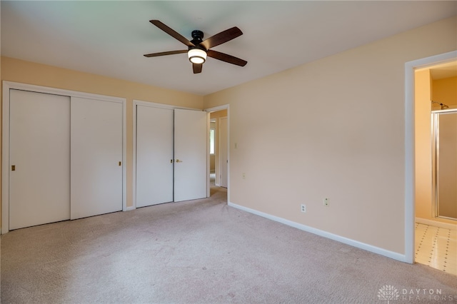 4424 Appleton Pl, Kettering, OH 45440 - unfurnished bedroom featuring two closets, carpet floors, and ceiling fan