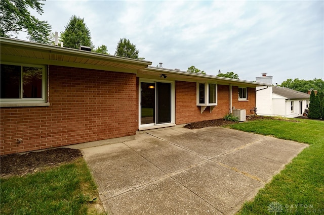 4424 Appleton Pl, Kettering, OH 45440 - rear view of house with a patio area, a yard, and brick siding