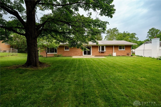 4424 Appleton Pl, Kettering, OH 45440 - rear view of property featuring a lawn and brick siding