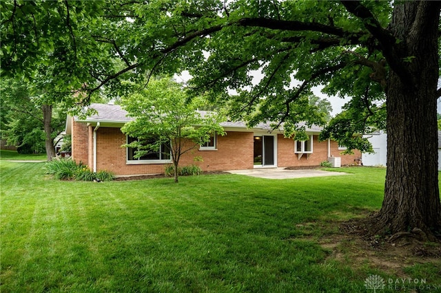 4424 Appleton Pl, Kettering, OH 45440 - rear view of house featuring brick siding, a patio area, and a yard