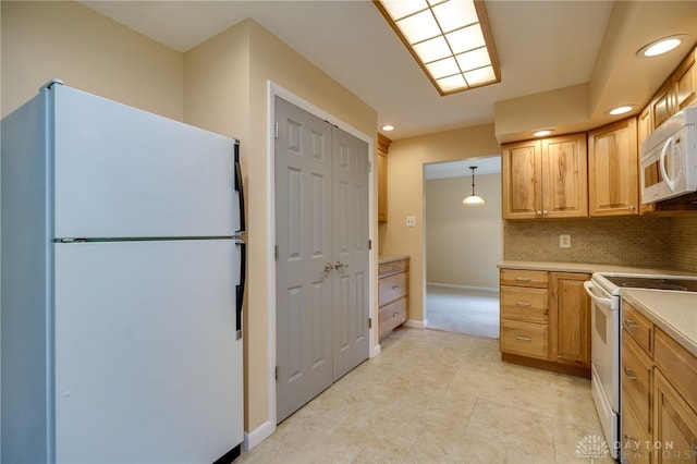 4424 Appleton Pl, Kettering, OH 45440 - kitchen featuring white appliances, light countertops, backsplash, recessed lighting, and pendant lighting