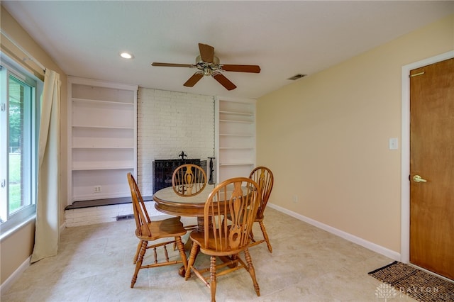 4424 Appleton Pl, Kettering, OH 45440 - dining area featuring a ceiling fan, healthy amount of natural light, a fireplace, built in shelves, and recessed lighting