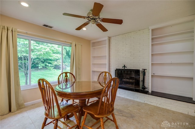 4424 Appleton Pl, Kettering, OH 45440 - dining area featuring built in shelves, ceiling fan, tile patterned flooring, a fireplace, and recessed lighting