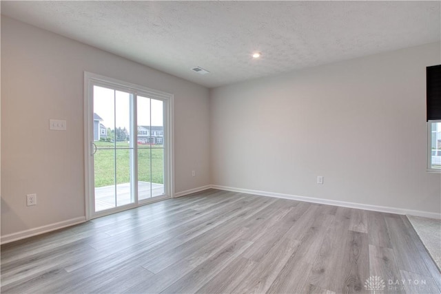 95 Whitney Way, West Milton, OH 45383 - spare room with light wood-style flooring, baseboards, a textured ceiling, and recessed lighting