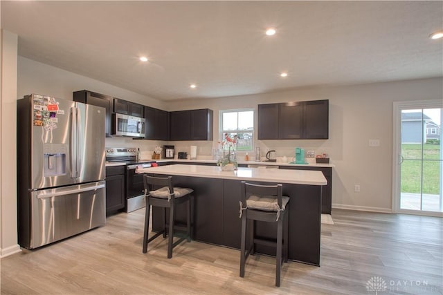 95 Whitney Way, West Milton, OH 45383 - kitchen with appliances with stainless steel finishes, light countertops, plenty of natural light, light wood-style flooring, and recessed lighting