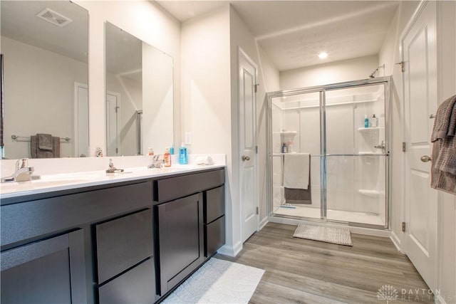 95 Whitney Way, West Milton, OH 45383 - bathroom with a shower stall, double vanity, and wood finished floors