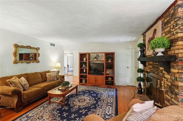 6007 Valleybrook Dr, Middletown, OH 45044 - living room featuring hardwood / wood-style floors and a brick fireplace