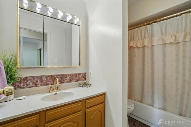 6007 Valleybrook Dr, Middletown, OH 45044 - full bathroom with vanity, toilet, decorative backsplash, and shower / tub combo