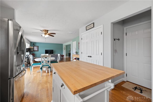 1750 Greentree Meadows Dr, Lebanon, OH 45036 - kitchen with wooden counters, stainless steel refrigerator with ice dispenser, light wood-style flooring, a ceiling fan, and white cabinets