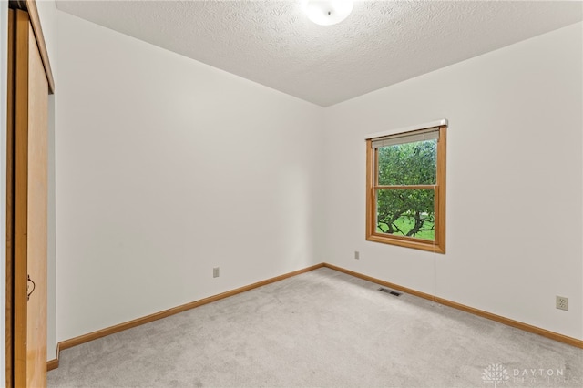1410 Hunter Ct, Troy, OH 45373 - carpeted empty room with baseboards and a textured ceiling