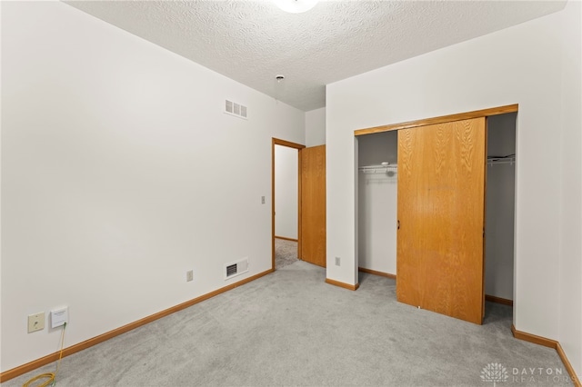 1410 Hunter Ct, Troy, OH 45373 - unfurnished bedroom featuring carpet flooring, a closet, and a textured ceiling