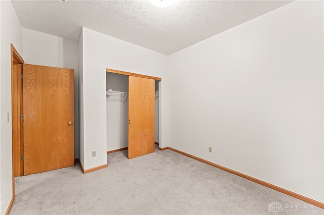 1410 Hunter Ct, Troy, OH 45373 - unfurnished bedroom with carpet floors, a closet, and a textured ceiling