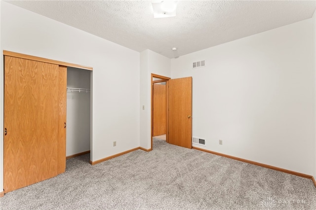 1410 Hunter Ct, Troy, OH 45373 - unfurnished bedroom with carpet floors, a closet, and a textured ceiling