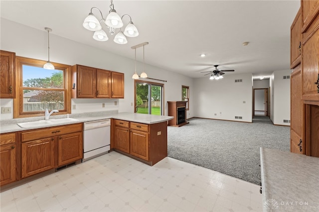 1410 Hunter Ct, Troy, OH 45373 - kitchen featuring white dishwasher, light countertops, a peninsula, a fireplace, and light colored carpet