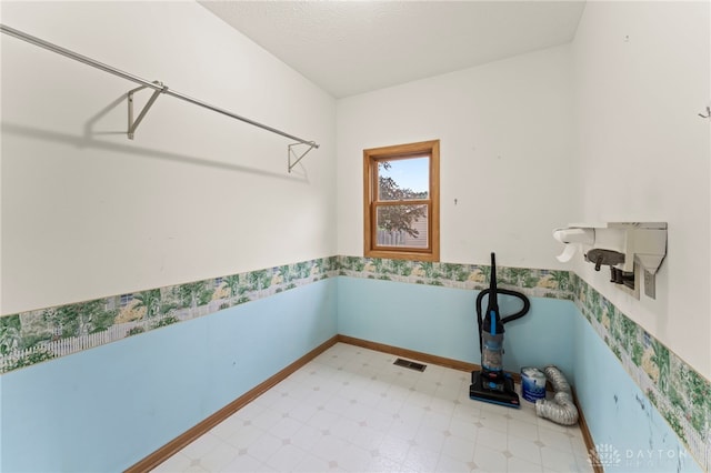 1410 Hunter Ct, Troy, OH 45373 - laundry area featuring tile patterned floors and a wainscoted wall