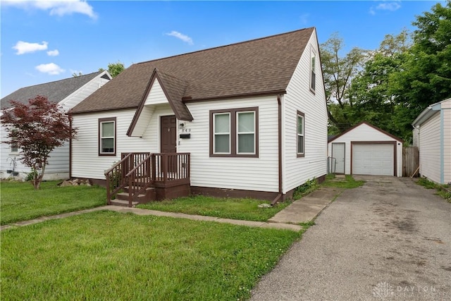 849 Princeton Ave, Fairborn, OH 45324 - view of front of house featuring asphalt driveway, a shingled roof, an outdoor structure, and a detached garage