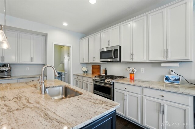 1596 Amberley Ct, Beavercreek Twp, OH 45385 - kitchen with appliances with stainless steel finishes, a sink, recessed lighting, white cabinetry, and light stone countertops