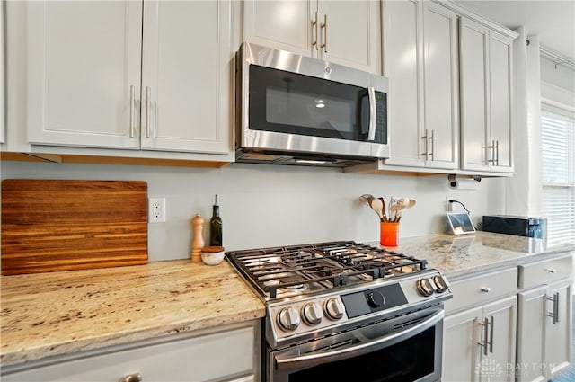 1596 Amberley Ct, Beavercreek Twp, OH 45385 - kitchen with appliances with stainless steel finishes, light stone countertops, and white cabinetry