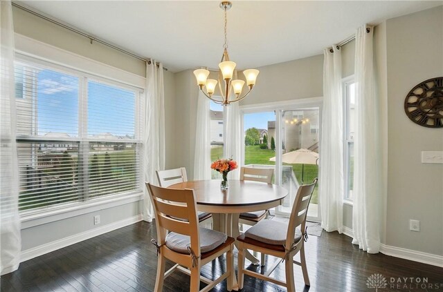 1596 Amberley Ct, Beavercreek Twp, OH 45385 - dining room with a chandelier, dark wood-style floors, and baseboards