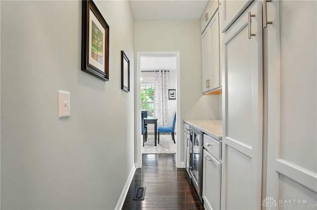 1596 Amberley Ct, Beavercreek Twp, OH 45385 - hall featuring dark wood-style floors, baseboards, and beverage cooler