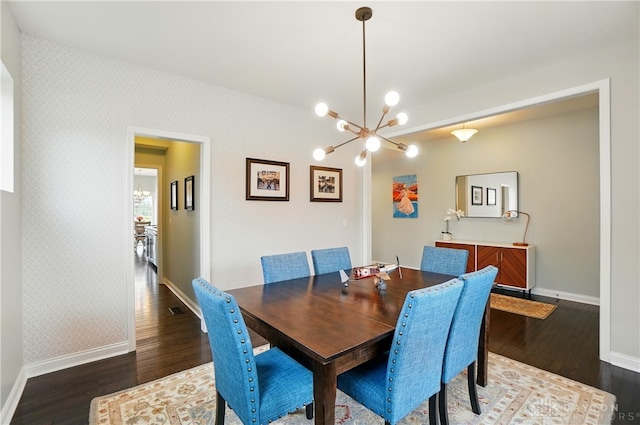 1596 Amberley Ct, Beavercreek Twp, OH 45385 - dining space with a chandelier, baseboards, wallpapered walls, and wood finished floors