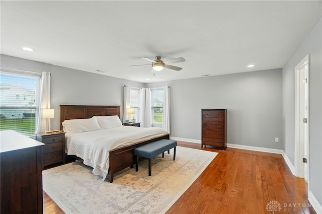 1596 Amberley Ct, Beavercreek Twp, OH 45385 - bedroom featuring multiple windows, wood finished floors, baseboards, ceiling fan, and recessed lighting