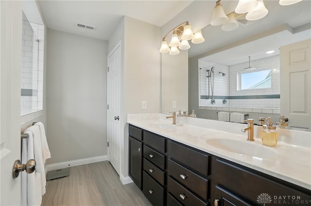 1596 Amberley Ct, Beavercreek Twp, OH 45385 - full bathroom featuring double vanity, a tile shower, and baseboards