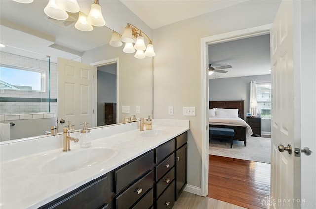 1596 Amberley Ct, Beavercreek Twp, OH 45385 - ensuite bathroom featuring double vanity, wood finished floors, baseboards, a chandelier, and a ceiling fan