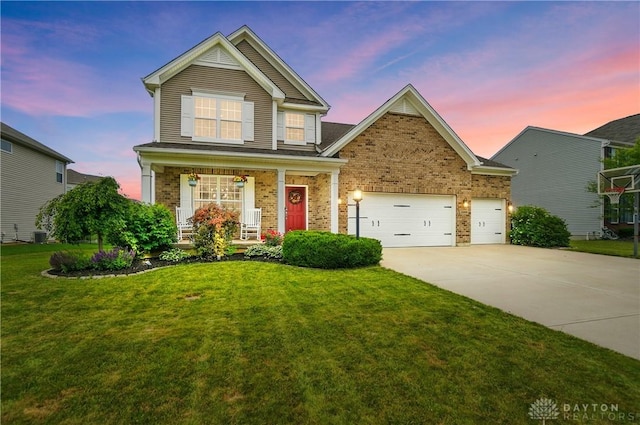 1596 Amberley Ct, Beavercreek Twp, OH 45385 - traditional-style home featuring driveway, covered porch, brick siding, a front lawn, and an attached garage