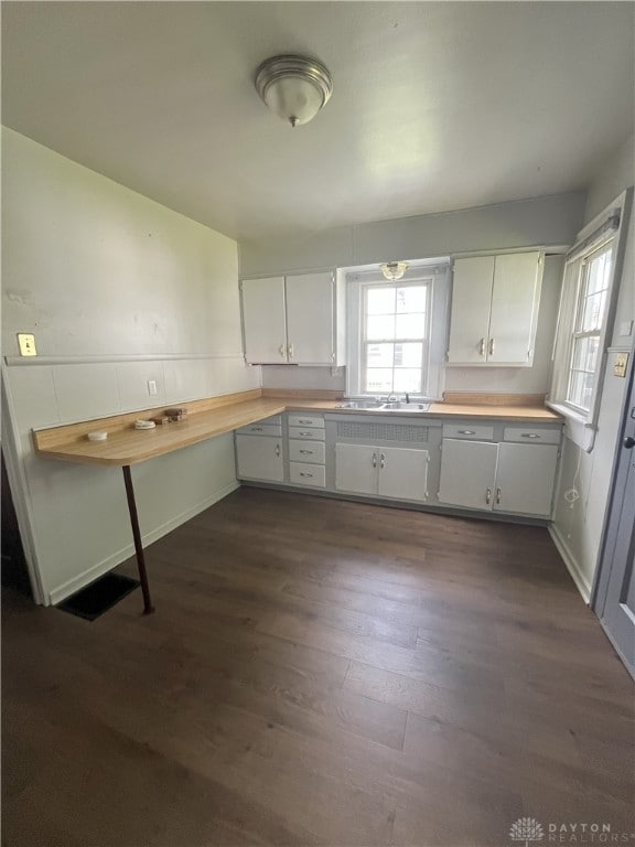 2821 E 5th St Unit 2819, Dayton, OH 45403 - kitchen with light countertops, dark wood-style floors, and white cabinets