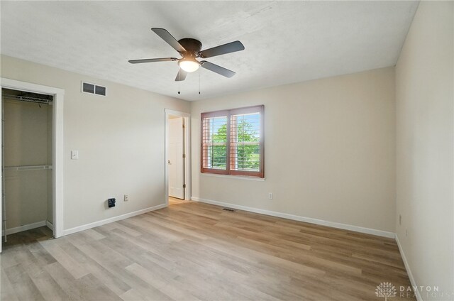 3682 Abbey Ln, Mechanicsburg, OH 43044 - unfurnished bedroom with light wood-style floors, baseboards, a closet, and a ceiling fan