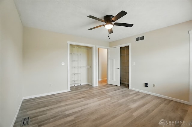 3682 Abbey Ln, Mechanicsburg, OH 43044 - unfurnished bedroom with baseboards, light wood-type flooring, a ceiling fan, and multiple closets