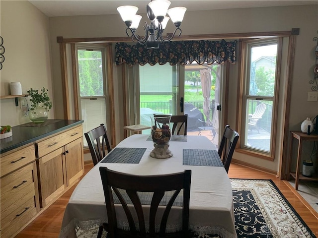 95 Fox Harbor Dr, Troy, OH 45373 - dining space with healthy amount of natural light, light wood-style flooring, and a chandelier