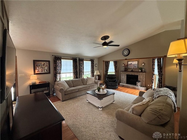 95 Fox Harbor Dr, Troy, OH 45373 - living room with wood finished floors, lofted ceiling, a ceiling fan, and a fireplace