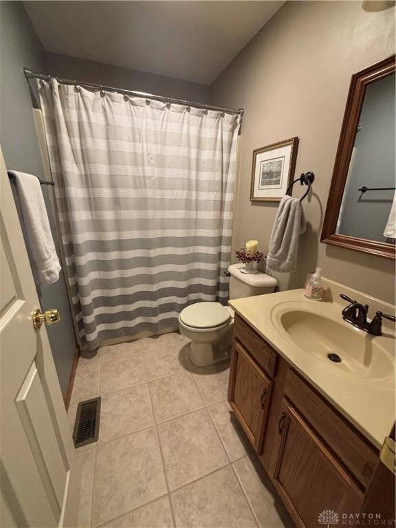 95 Fox Harbor Dr, Troy, OH 45373 - bathroom featuring vanity, toilet, tile patterned floors, and a shower with shower curtain