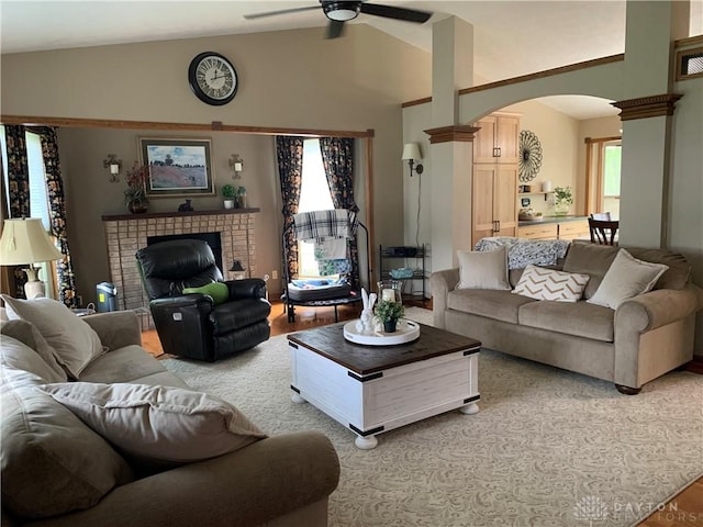 95 Fox Harbor Dr, Troy, OH 45373 - living room with arched walkways, a brick fireplace, a ceiling fan, lofted ceiling, and light wood-type flooring