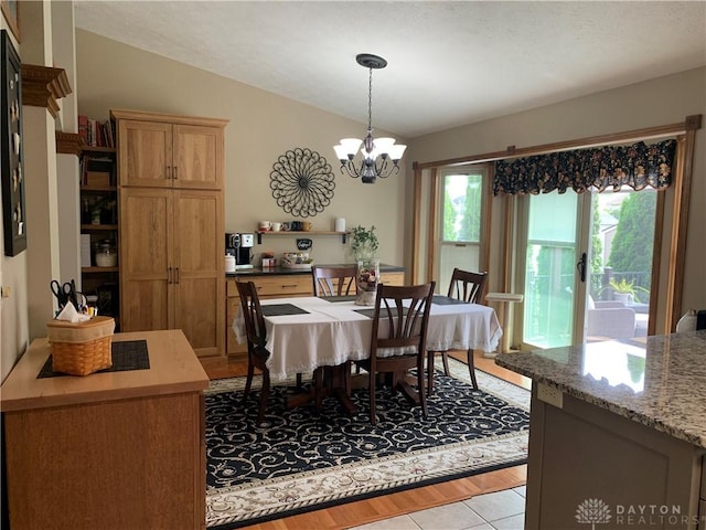 95 Fox Harbor Dr, Troy, OH 45373 - dining area with lofted ceiling, a chandelier, and light tile patterned floors