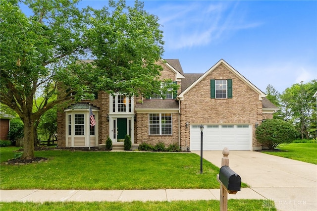2159 Bassett Ct, Beavercreek, OH 45434 - view of front of home featuring concrete driveway, a garage, a front lawn, and brick siding