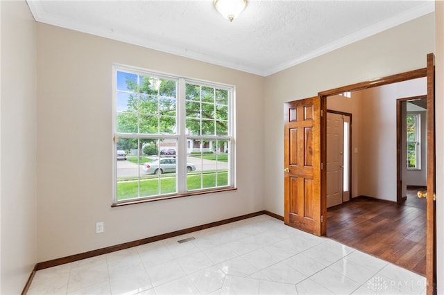 2159 Bassett Ct, Beavercreek, OH 45434 - spare room with crown molding, baseboards, and a textured ceiling
