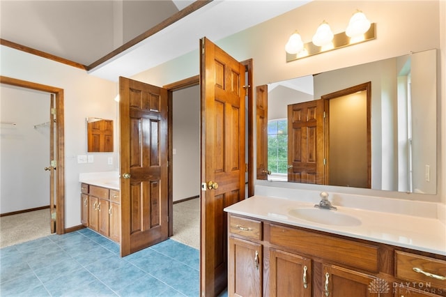 2159 Bassett Ct, Beavercreek, OH 45434 - bathroom with vanity, tile patterned floors, a walk in closet, and baseboards