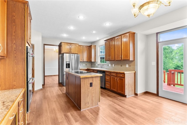 2159 Bassett Ct, Beavercreek, OH 45434 - kitchen featuring appliances with stainless steel finishes, light countertops, light wood-type flooring, recessed lighting, and a center island